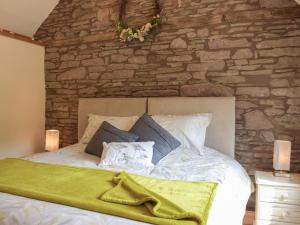 a bedroom with a bed with a stone wall at Gooses Roost - Uk32096 in Dorstone +10 photos