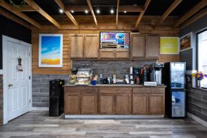 a kitchen with a counter and a refrigerator at Days Inn by Wyndham Burns in Burns
