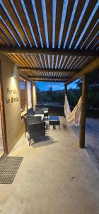 a pavilion with benches and a hammock on a patio at Morada La Granja in Minas +12 photos