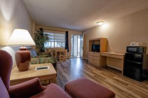 a living room with a couch and a table at Days Inn by Wyndham Burns in Burns