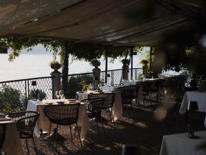 a row of tables with white table cloths on them at Il Sole Di Ranco in Ranco
