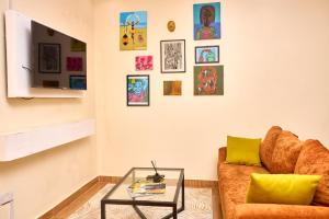 a living room with a couch and a glass table at Oasis Guesthouse Juba in Juba