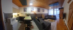 a living room with a couch and a kitchen at Cosy Apartment in Tauplitz +13 photos