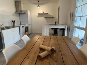 a wooden table with a baseball bat on it in a kitchen at L'etable in Orx