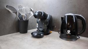 a counter with a coffee maker and a blender at Komody Apartments in Delphi