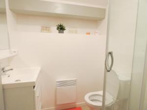 a white bathroom with a toilet and a sink at L'etable in Orx +18 photos