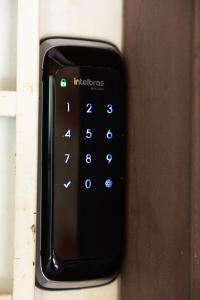 a close up of a remote control on a door at Oca Delfim in Delfim Moreira