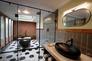 a bathroom with a black sink and a tub at Seascape Beach Retreat in Kannur +29 photos