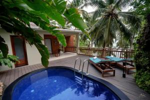 a resort with a swimming pool and a patio at Seascape Beach Retreat in Kannur