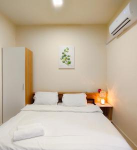 a bedroom with a bed and a picture on the wall at Studio at Mesahill Nilai by D'KAY HOMES with Mall, near USIM KLIA in Nilai +275 photos