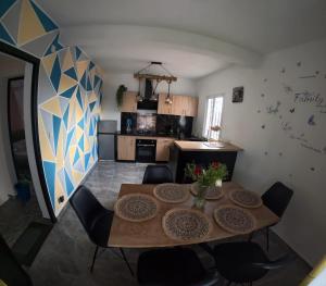 a living room with a table and chairs and a kitchen at Akany Tsitoha in Tanjombato
