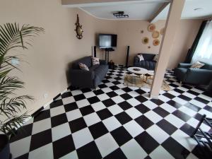 a living room with a black and white checkered floor at Akany Tsitoha in Tanjombato