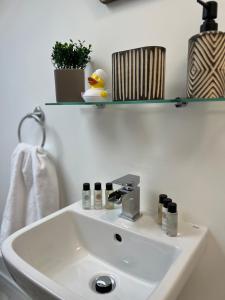 a white bathroom sink with a rubber duck on it at The courtyard bar, kitchen, rooms in Falkirk +26 photos
