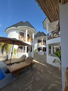a villa with a hammock and a resort at Jumbo Resort in Paje