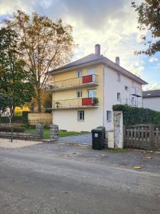 a large white house with a fence in front of it at Sasseres Appart Souplex 6 pers Extérieur in Argelès-Gazost