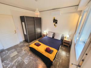a bedroom with a large bed with a yellow blanket at Sasseres Appart Souplex 6 pers Extérieur in Argelès-Gazost