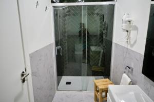 a shower with a glass door in a bathroom at Mid-Atlantic House in Angra do Heroísmo +58 photos