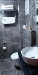 a bathroom with a white sink and a toilet at ANKARA EFEs OTEL in Altındağ