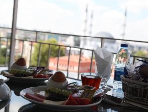 two plates of food on a table with eggs and fruit at ANKARA EFEs OTEL in Altındağ +15 photos