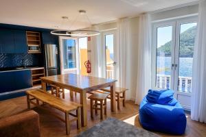 a living room with a table and a blue couch at Mid-Atlantic House in Angra do Heroísmo