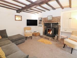 a living room with a couch and a fireplace at Roseville in Matlock