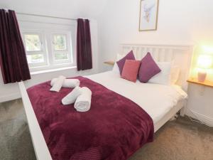 a bedroom with a bed with two towels on it at Roseville in Matlock