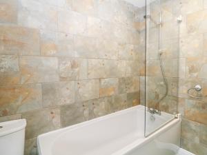 a bathroom with a shower and a tub and a toilet at Roseville in Matlock +32 photos