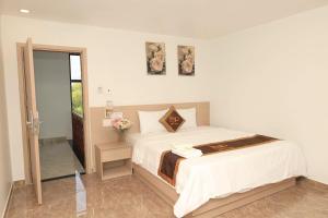 a bedroom with a large bed and a mirror at Hugo Hotel in Phú Quốc +28 photos