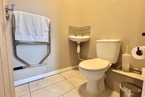 a bathroom with a toilet and a sink at Sunset Cottage in Llanddulas +8 photos