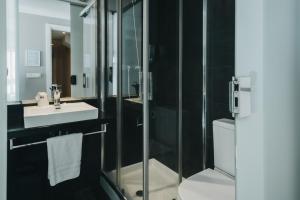a bathroom with a shower and a sink and a toilet at Pension Ondarra Autocheck-In in San Sebastián +49 photos