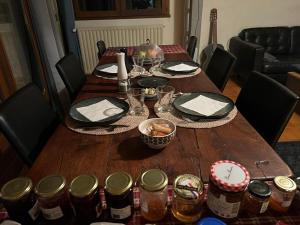 a wooden table with plates and glasses on it at Les Figuiers Bleus in Cravencères