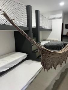 a room with two beds and a hammock at Apartamento Zion reserve suites in Conde