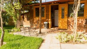 a wooden house with a porch and chairs in front of it at Casa Mocha by RentalsPro - Vourvourou Halkidiki in Vourvourou +26 photos