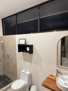 a bathroom with a toilet and a sink at Casa Rio Tortuga - Butterfly in Ojochal