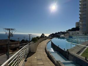a view of a swimming pool next to a building at Incredible Ocean View in Viña del Mar