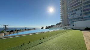 a view of a building with a field of grass at Incredible Ocean View in Viña del Mar