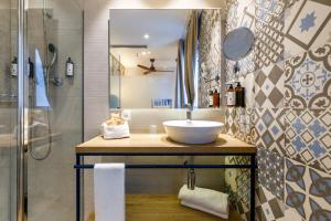 a bathroom with a sink and a shower at Petit Palace Plaza de la Reina in Valencia +53 photos