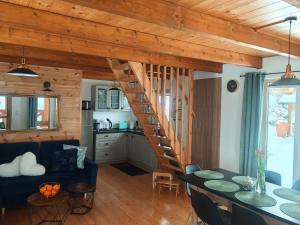 a living room with a spiral staircase in a house at DOMKI KOLOROWE in Marciszów