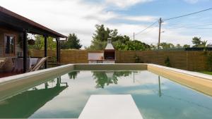 a swimming pool in the backyard of a house at Casa Mocha by RentalsPro - Vourvourou Halkidiki in Vourvourou
