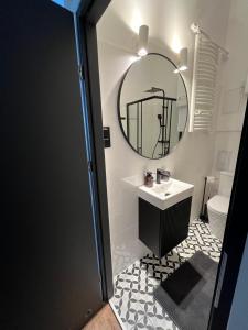 a bathroom with a sink and a mirror at Old Town Rynek Apartament in Grudziądz