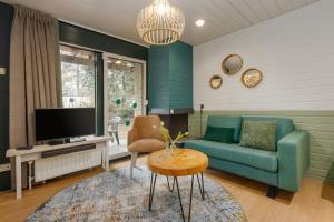 a living room with a couch and a tv at Center Parcs Apartments Erperheide in Peer