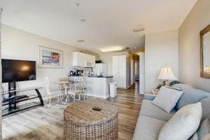 a living room with a couch and a table at Grand Caribbean 104 in Orange Beach