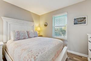 a bedroom with a bed and a window at Grand Caribbean 104 in Orange Beach +22 photos