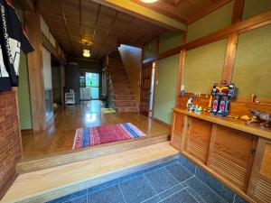a hallway of a home with a room with a stairway at ゲストハウス虎のいえ in Sukumo