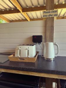 a toaster and a blender sitting on a table at Gypsy bow top caravan in Llangrannog