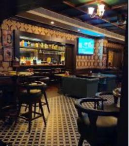 a restaurant with a bar with tables and chairs at Sun Stayz Inn T - Nagar Chennai in Chennai