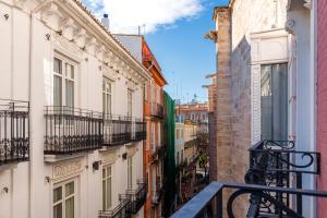 an alley in a city with buildings at Petit Palace Plaza de la Reina in Valencia