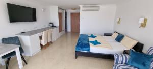 a room with a couch and a table and a tv at Villa LeLux in Mikołajki +99 photos