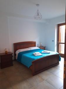 a bedroom with a bed with a blue blanket at Casa Molines in Giaveno