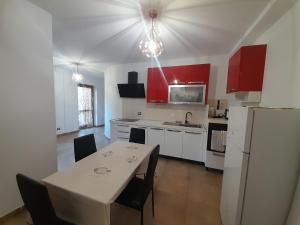 a kitchen with a table with chairs and a refrigerator at Casa Molines in Giaveno